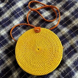 Yellow Rattan shoulder bag w brown leather accents.